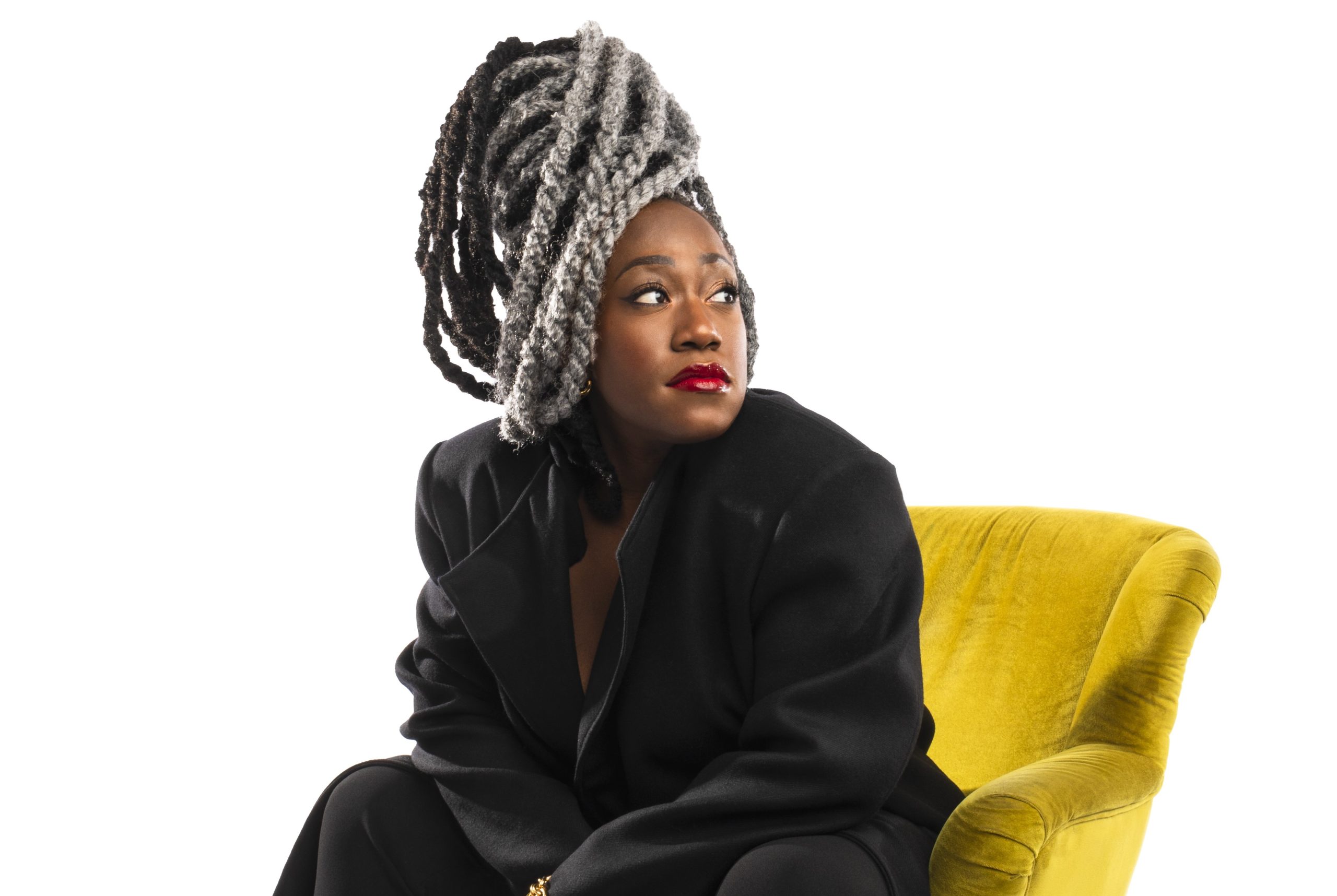 Photo of Mélissa Laveaux sitting on a yellow chair