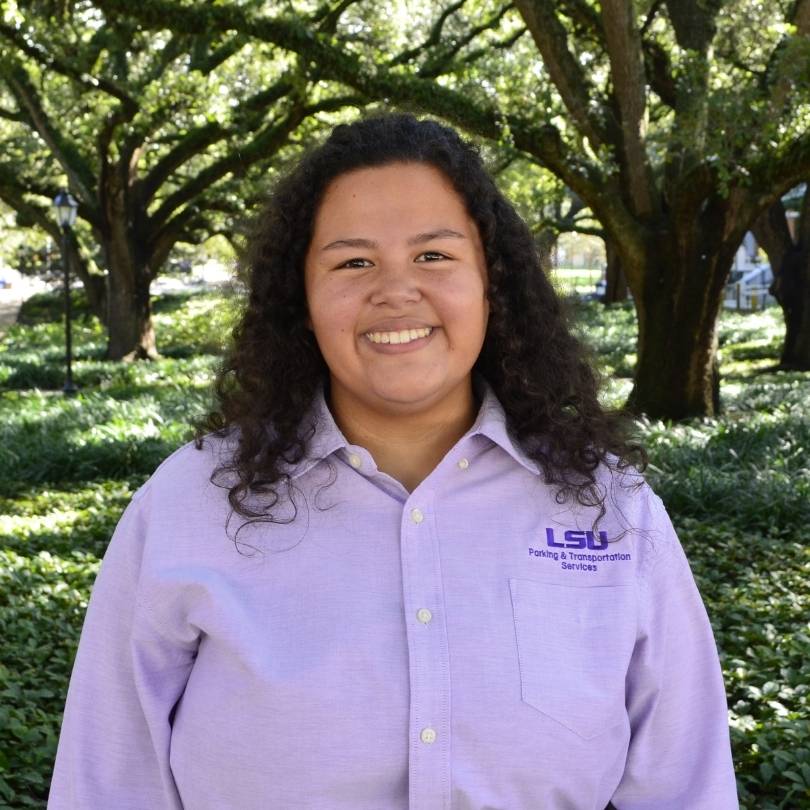 Smiling woman in purple PTS polo