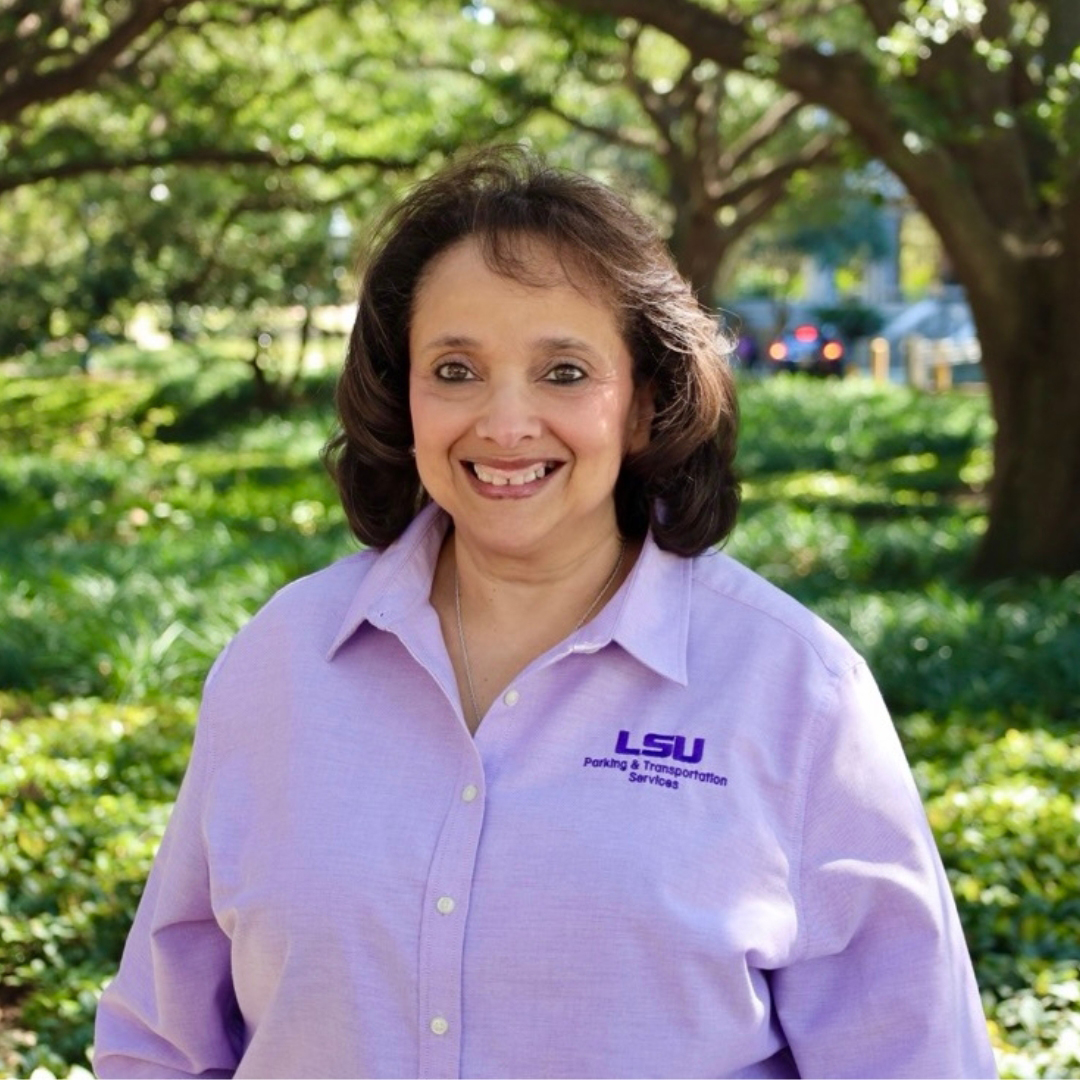 Smiling woman in purple PTS polo